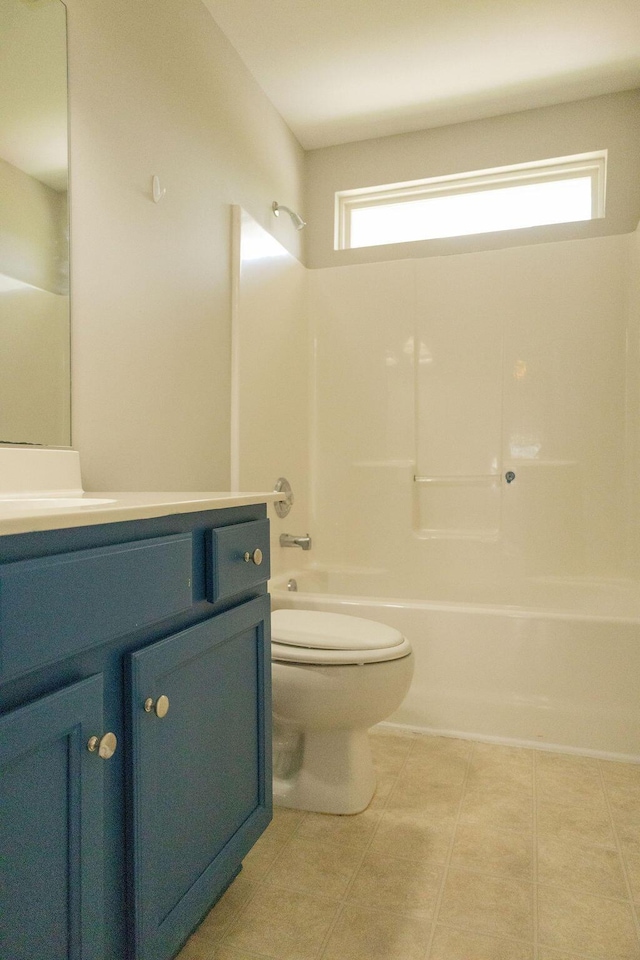 full bathroom with toilet, washtub / shower combination, a healthy amount of sunlight, and vanity