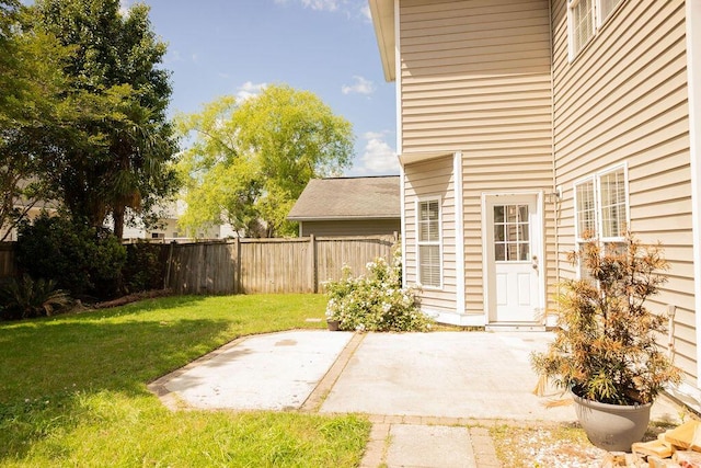 view of yard featuring fence and a patio