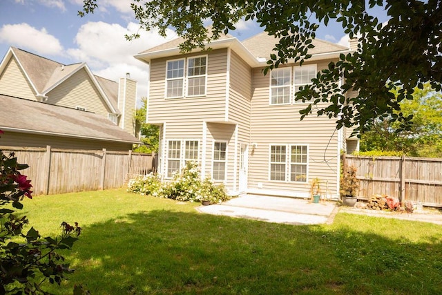 rear view of house featuring a lawn, a patio, and fence