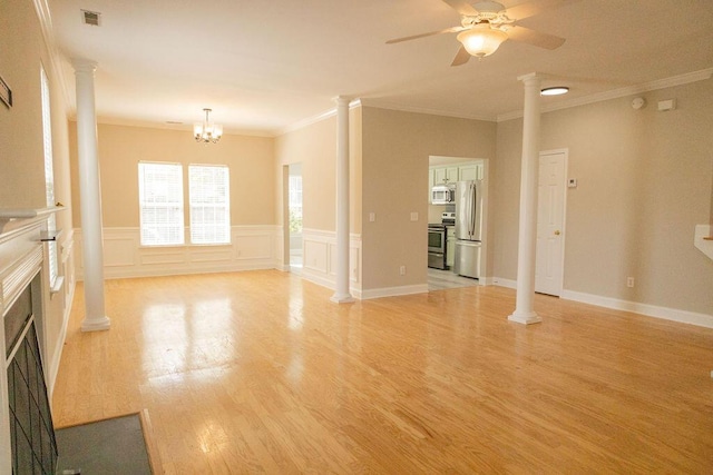 unfurnished living room featuring ceiling fan, visible vents, light wood-style floors, ornamental molding, and ornate columns