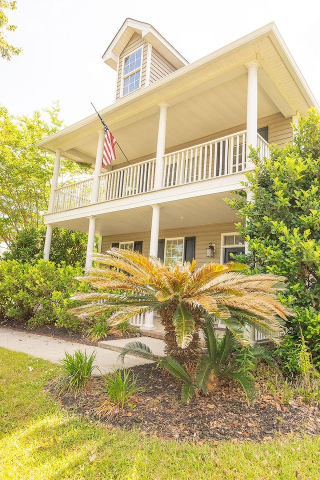 back of property featuring a balcony