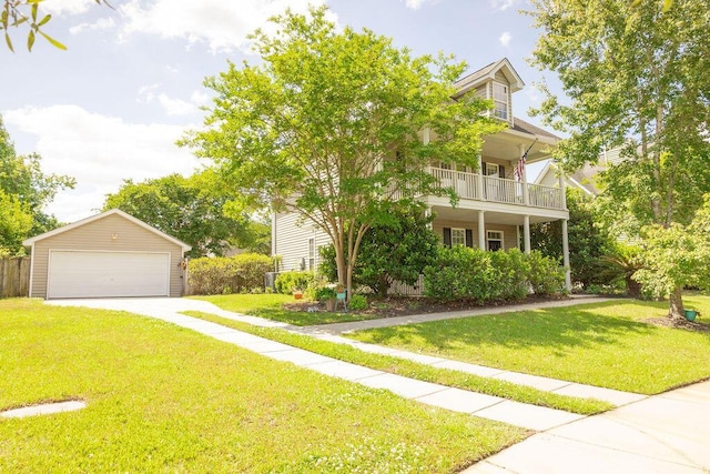 view of front facade with fence, a garage, a front yard, an outbuilding, and a balcony