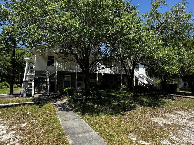927 N Lemacks St, Walterboro, SC 29488 - view of property hidden behind natural elements with stairway and a porch