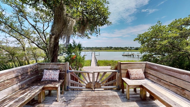 deck with a water view and a dock