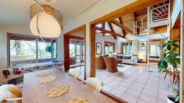 dining area with vaulted ceiling with beams, light tile patterned floors, and wood ceiling