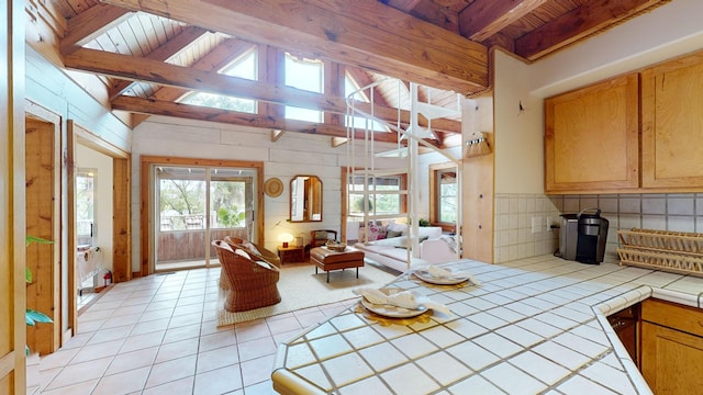 tiled living room featuring beamed ceiling, high vaulted ceiling, and wooden ceiling