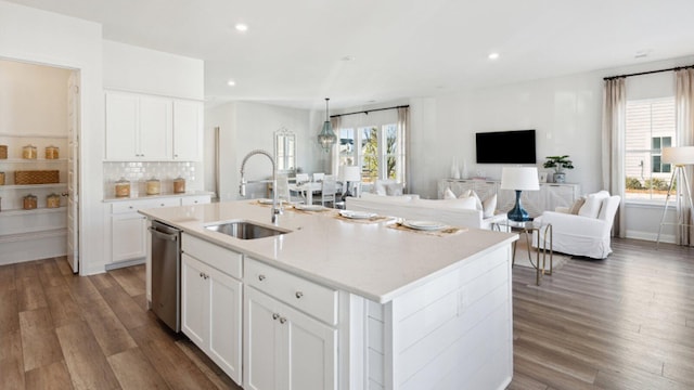 304 Archar St, Summerville, SC 29486 - kitchen featuring stainless steel dishwasher, wood finished floors, white cabinets, an island with sink, and light countertops
