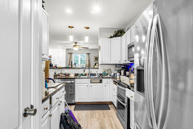 kitchen featuring appliances with stainless steel finishes, ceiling fan, white cabinetry, and sink