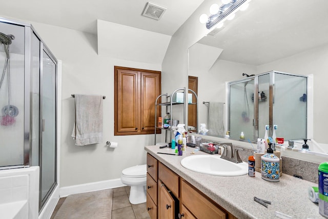 bathroom featuring a shower with door, vanity, toilet, and tile patterned flooring