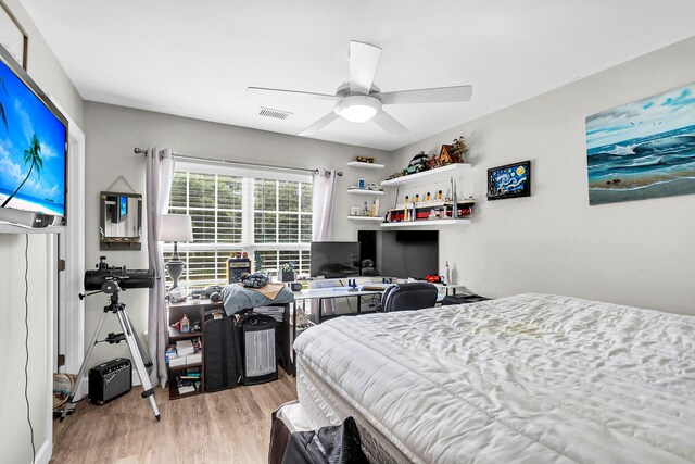 bedroom with ceiling fan and light hardwood / wood-style floors