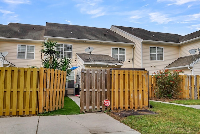 rear view of property with a yard