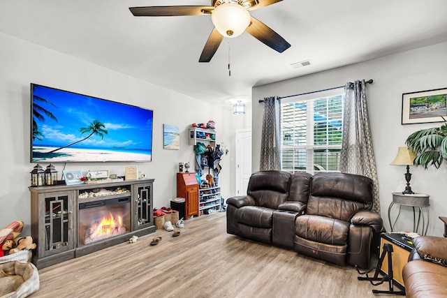 living room with ceiling fan and hardwood / wood-style floors