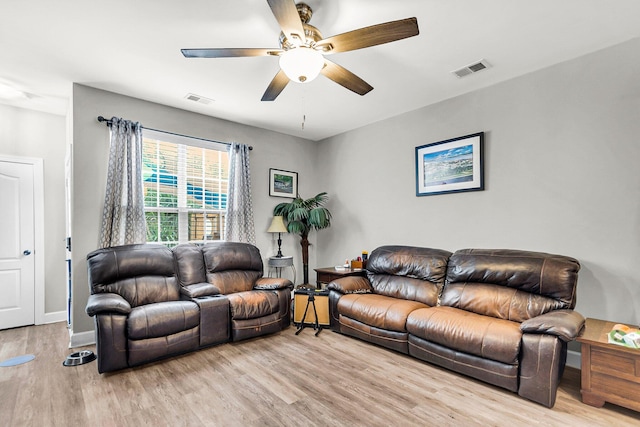 living room with ceiling fan and light hardwood / wood-style floors