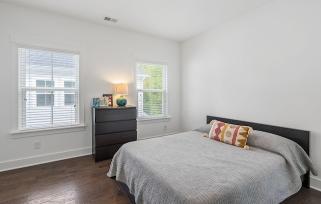 bedroom with dark hardwood / wood-style flooring