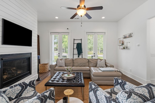 living room featuring ceiling fan, wood-type flooring, and french doors