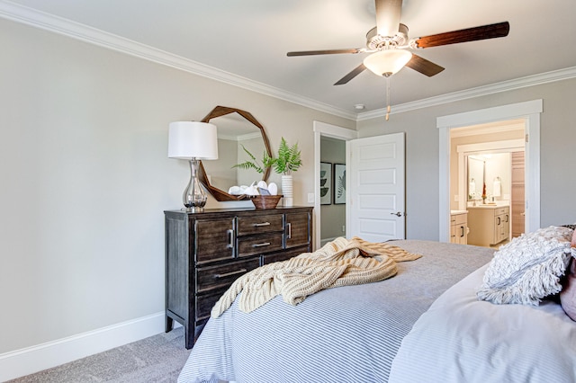 carpeted bedroom featuring ensuite bath, ceiling fan, and crown molding