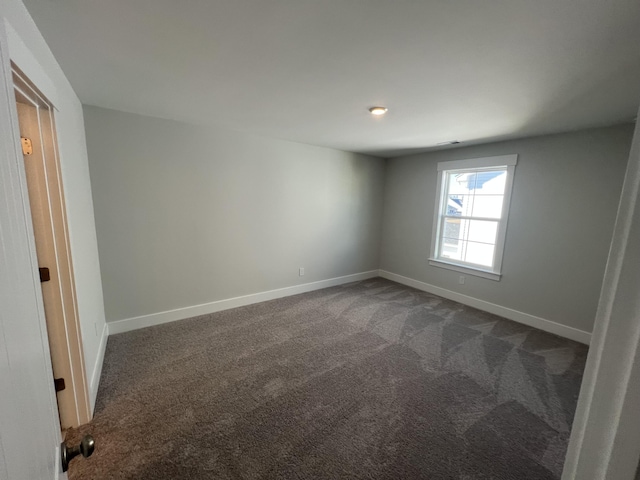 empty room with dark carpet