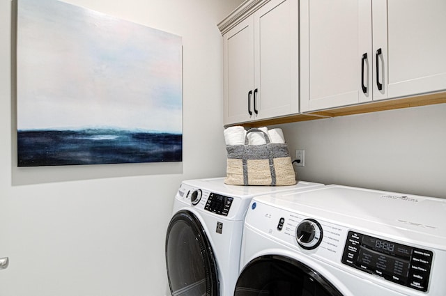 washroom featuring separate washer and dryer and cabinets