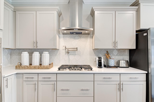 kitchen with white cabinetry, decorative backsplash, wall chimney exhaust hood, and stainless steel appliances