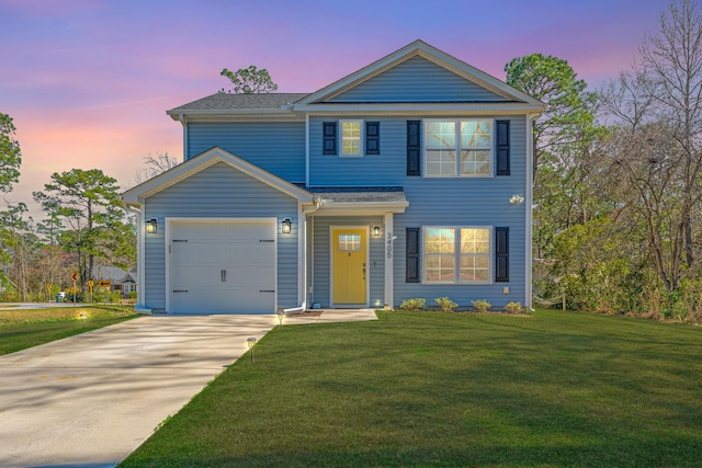 view of front of property featuring a yard, a garage, and driveway