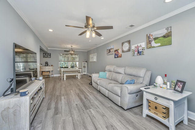 living area featuring light wood finished floors, visible vents, ceiling fan with notable chandelier, and crown molding