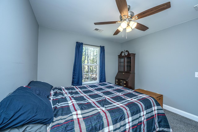 bedroom with visible vents, baseboards, ceiling fan, and carpet flooring