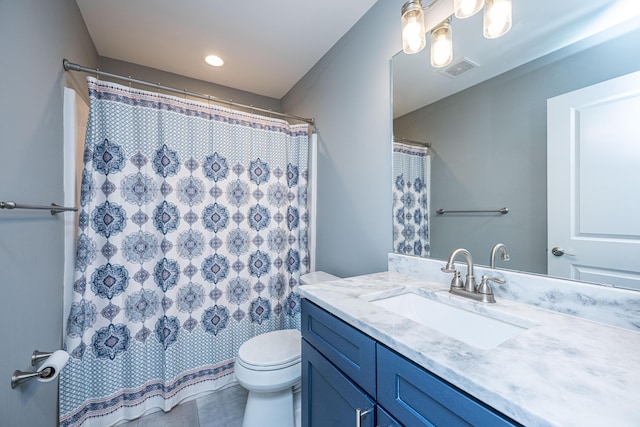 bathroom featuring visible vents, curtained shower, toilet, and vanity