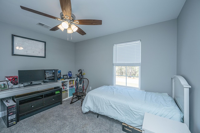 carpeted bedroom featuring visible vents and a ceiling fan