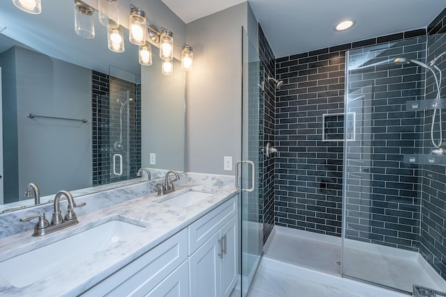 bathroom featuring double vanity, a shower stall, and a sink