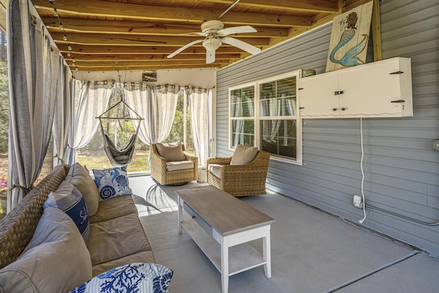 sunroom / solarium featuring beamed ceiling, wooden ceiling, and ceiling fan