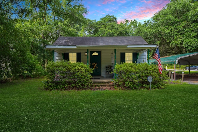 145 Ravenell Dr, Saint Stephen, SC 29479 - view of front of home with covered porch, a front yard, and a detached carport