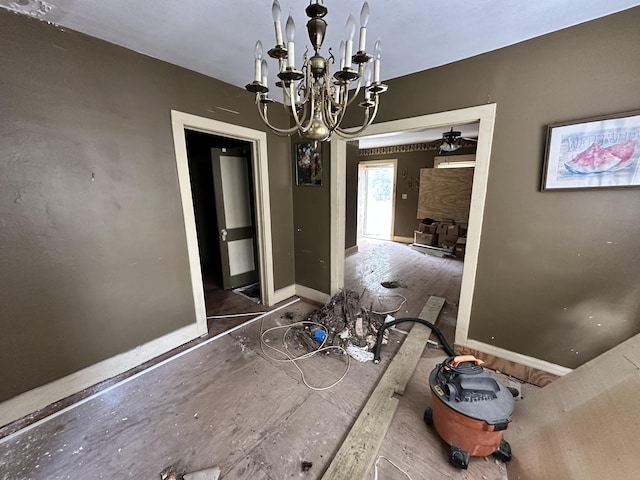 unfurnished dining area featuring a fireplace and a chandelier