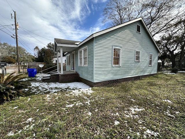 snow covered property with a lawn