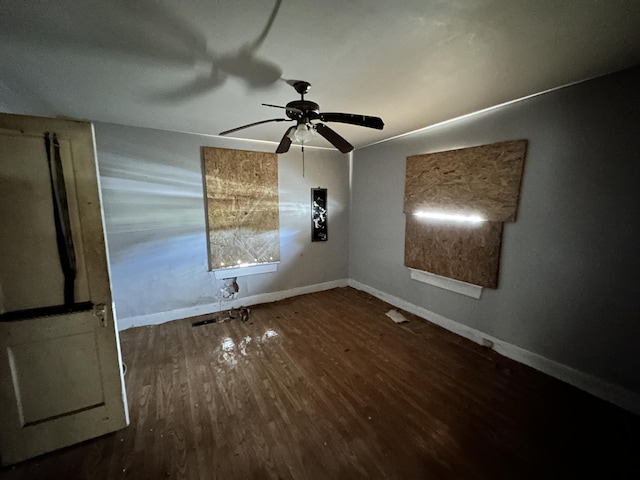 empty room featuring dark hardwood / wood-style flooring and ceiling fan