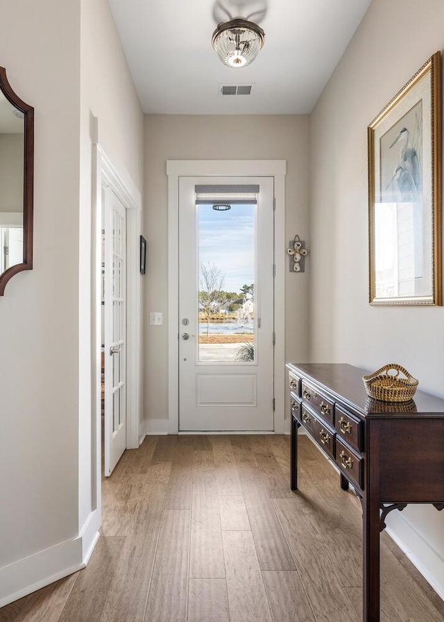 doorway with light wood-type flooring