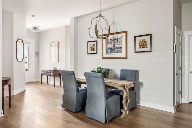 dining area with a chandelier and hardwood / wood-style flooring