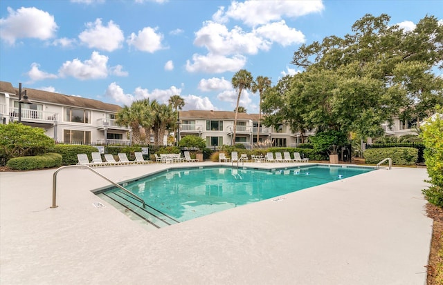 community pool featuring a patio and fence