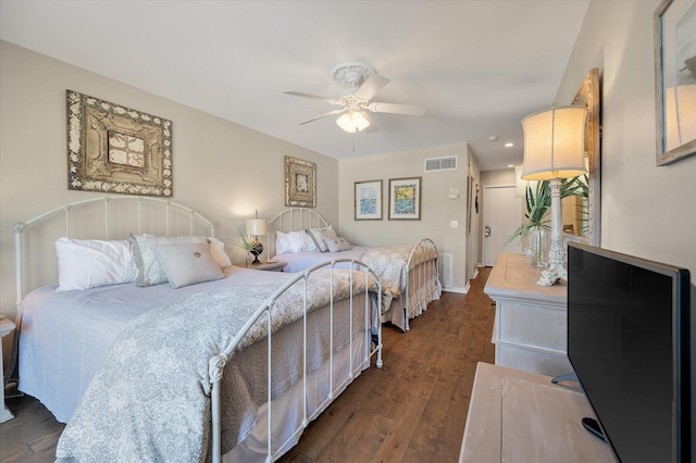 bedroom with visible vents, dark wood finished floors, baseboards, and ceiling fan