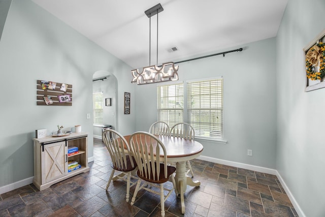 201 Maywood Dr, Moncks Corner, SC 29461 - dining space featuring stone tile floors, arched walkways, and a chandelier