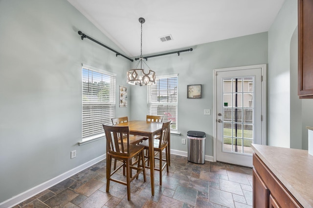 201 Maywood Dr, Moncks Corner, SC 29461 - dining area with a chandelier, stone tile floors, and lofted ceiling