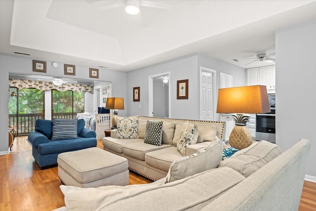 1025 Scaup Ct, Kiawah Island, SC 29455 - living room featuring a ceiling fan, wood finished floors, and a tray ceiling