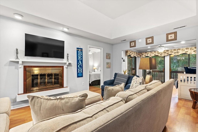 1025 Scaup Ct, Kiawah Island, SC 29455 - living room featuring wood finished floors, a glass covered fireplace, a ceiling fan, and recessed lighting