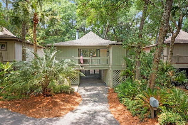 1025 Scaup Ct, Kiawah Island, SC 29455 - view of front facade featuring a carport, asphalt driveway, and roof with shingles