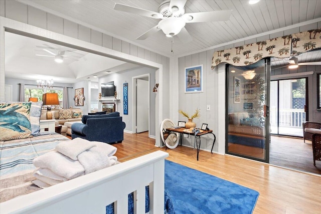 1025 Scaup Ct, Kiawah Island, SC 29455 - living area with ceiling fan, wood finished floors, a chandelier, and a glass covered fireplace