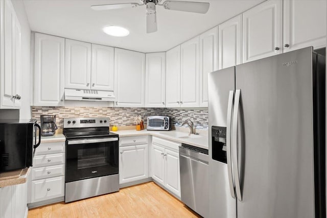 1025 Scaup Ct, Kiawah Island, SC 29455 - kitchen with stainless steel appliances, under cabinet range hood, light countertops, and white cabinets