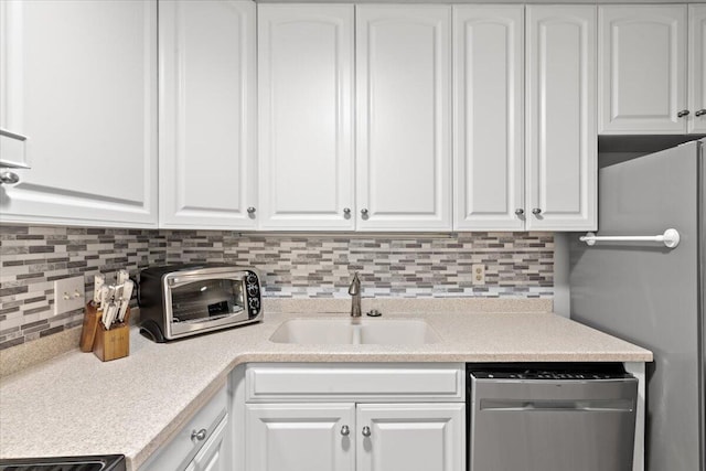 1025 Scaup Ct, Kiawah Island, SC 29455 - kitchen with stainless steel dishwasher, refrigerator, white cabinetry, decorative backsplash, and light countertops