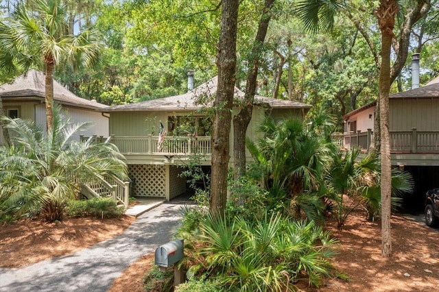 1025 Scaup Ct, Kiawah Island, SC 29455 - view of front facade featuring driveway, a carport, and stairway