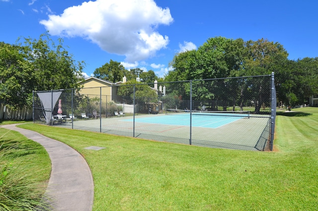 view of sport court with a yard