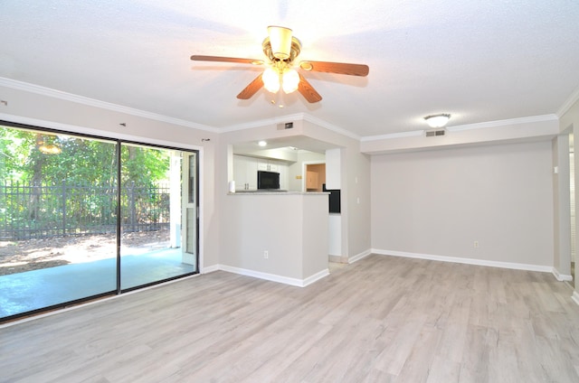 spare room featuring a textured ceiling, light hardwood / wood-style flooring, ceiling fan, and ornamental molding