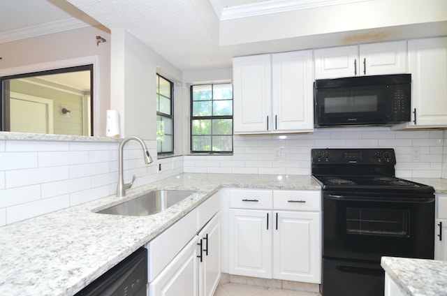 kitchen with light stone countertops, black appliances, sink, decorative backsplash, and white cabinetry